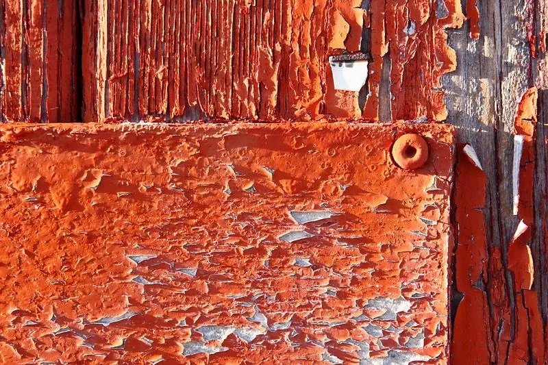 Close-up of old peeling paint on an exterior surface