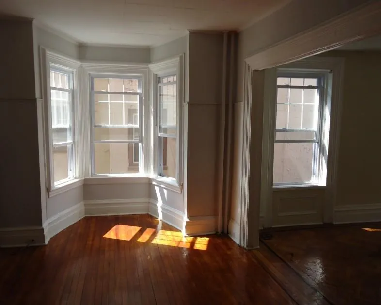 Empty room with a smooth, finished ceiling after popcorn removal
